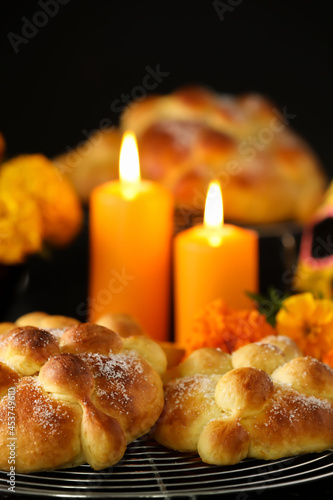 Bread of the dead and candles on dark background. Celebration of Mexico's Day of the Dead (El Dia de Muertos)