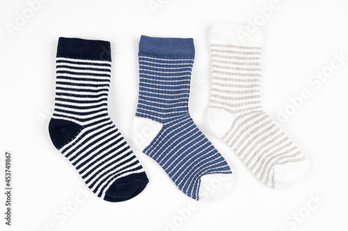 Three striped little baby boy socks isolated on white.