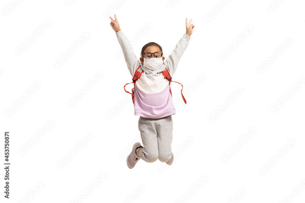 Asian little girl wearing mask showing two fingers and jumping, isolate on white background. Asian little girl wearing mask showing two fingers and jumping, isolate on white background.