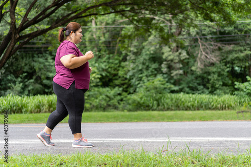Fat woman asian running, Does exercise for weight loss idea concept. © kromkrathog