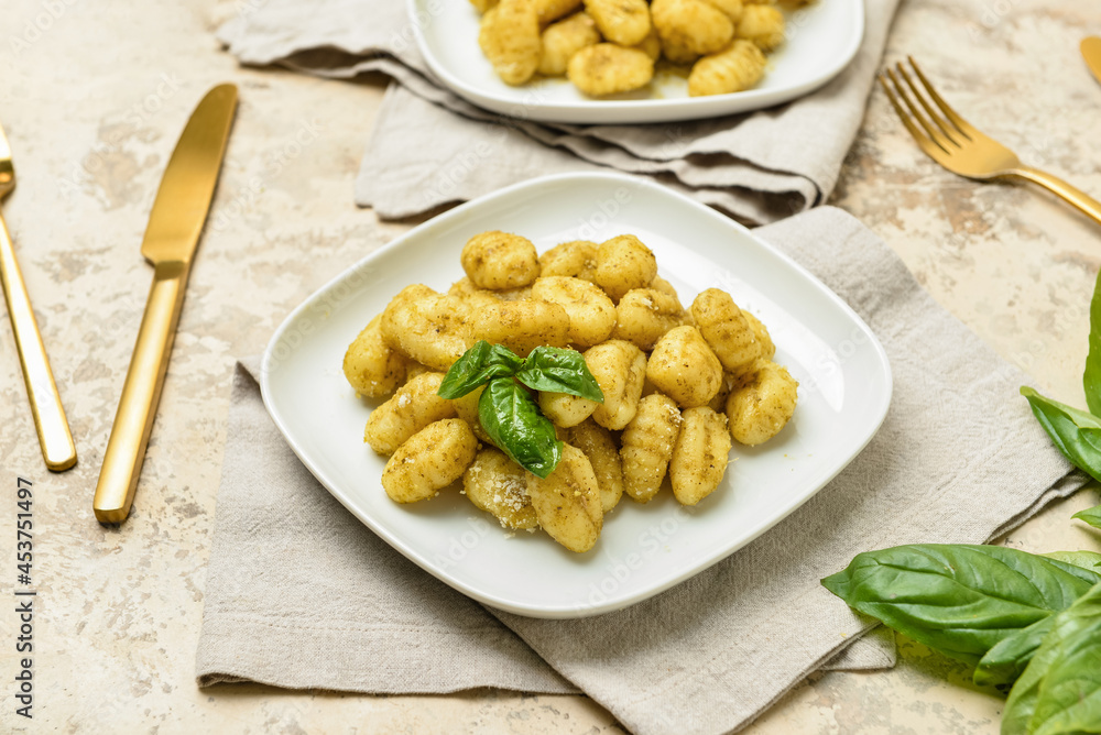 Plates with tasty pesto gnocchi on table Plates with tasty pesto gnocchi on table
