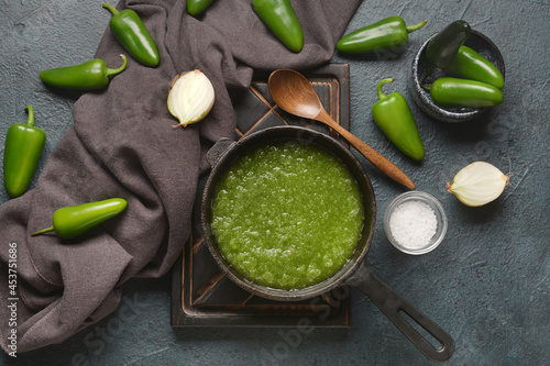 Frying pan with Tomatillo Salsa Verde sauce and ingredients on dark background photo