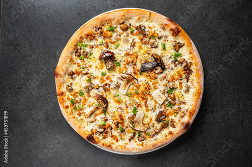 pizza with mushrooms on the black background
