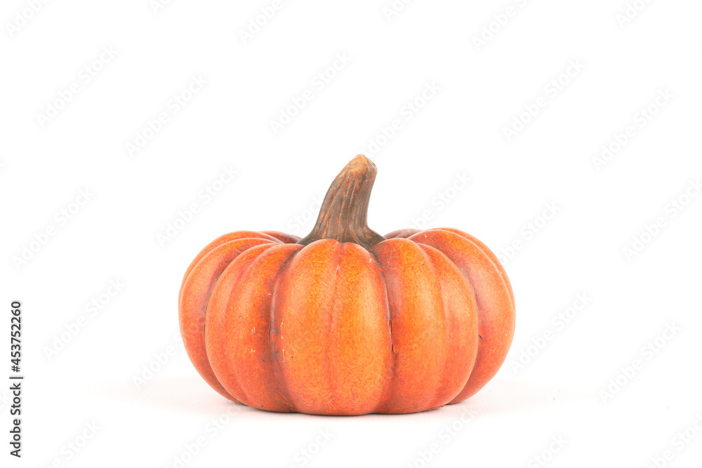 Obraz premium An orange pumpkin made out of clay isolated on white