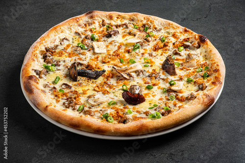 pizza with mushrooms on the black background