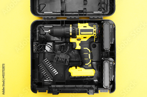 The yellow-black screwdriver on a yellow background, a set of bits.