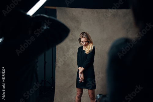 blonde girl in studio posing for photographer fashion lifestyle