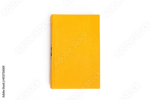 Yellow closed book with blank cover on white background