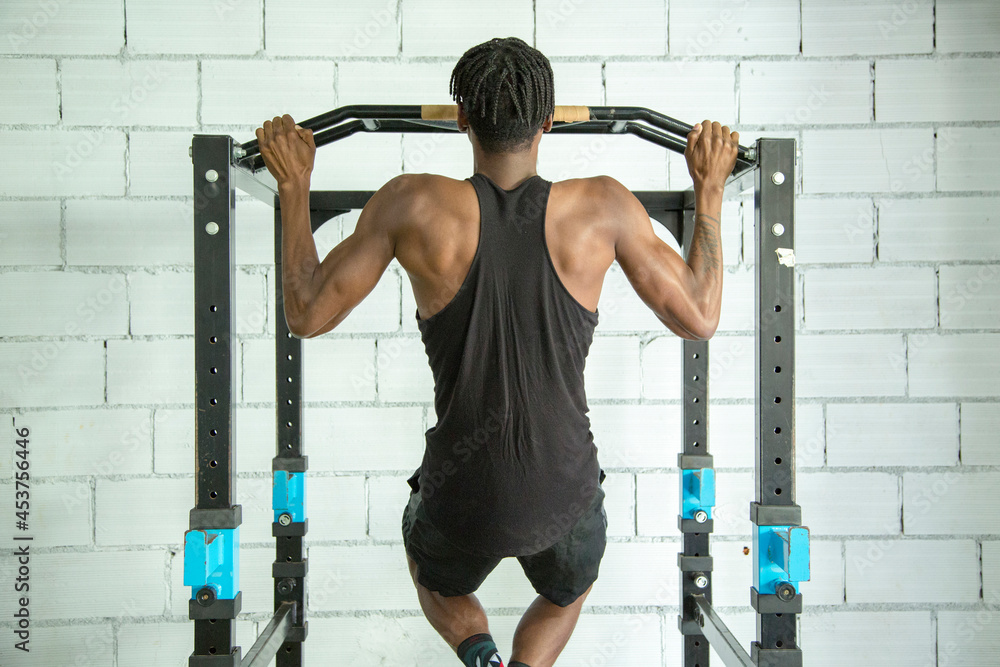Fototapeta premium anonymous young african american man doing sports in the gym