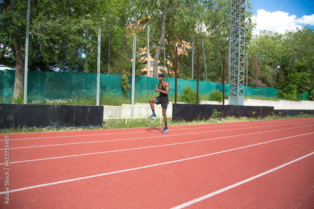 young african american man practicing running on running track young african american man practicing running on running track