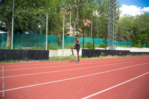 young african american man practicing running on running track