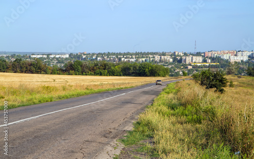 Country road leading to the city. © Сергей Васильченко