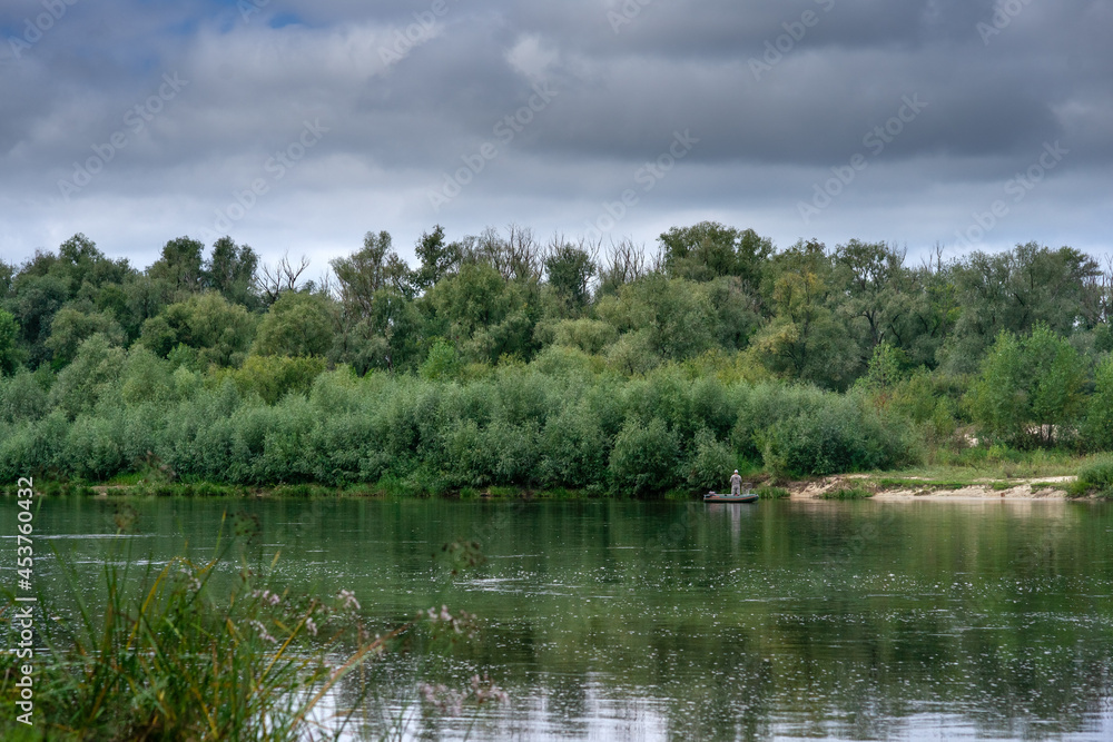 Beautiful view of Ukrainian Desna river, calm waters, dramatic skies