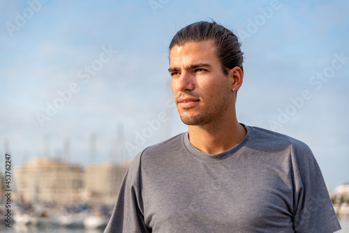 Portrait of young latin man after doing exercise outdoors