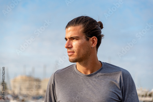 Portrait of young latin man after doing exercise outdoors
