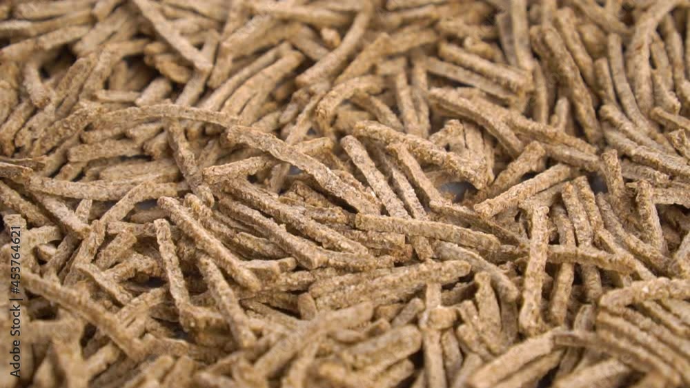 Cereal wheat fiber sticks. Close up. Falling onto a heap in slow motion Cereal wheat fiber sticks. Close up. Falling onto a heap in slow motion