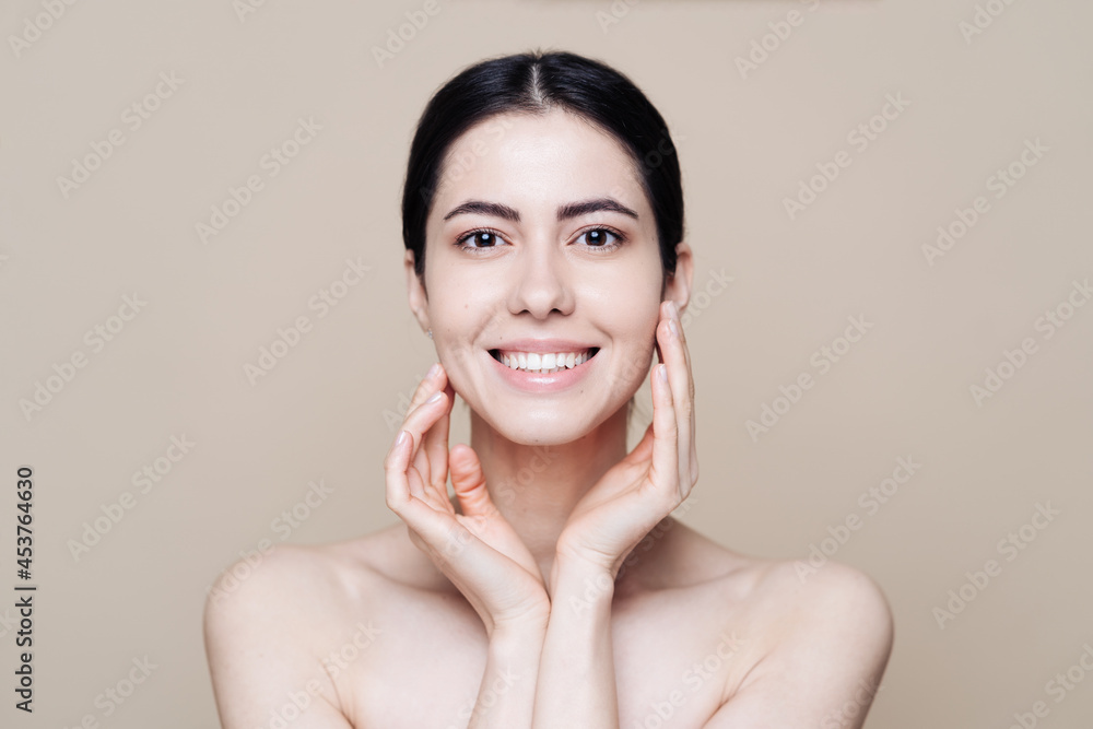 Beautiful young Caucasian woman with clean fresh skin on beige background, Face care, Facial treatment, Cosmetology, beauty and spa, brunette women portrait Beautiful young Caucasian woman with clean fresh skin on beige background, Face care, Facial treatment, Cosmetology, beauty and spa, brunette women portrait
