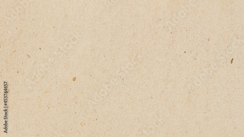 Cardboard, beige paper texture cardboard background, surface with small inclusions of cellulose