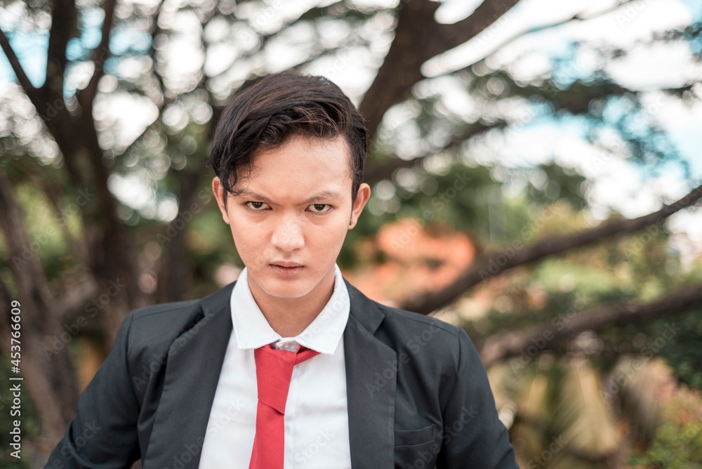 An angry delinquent university student with a threatening stare and