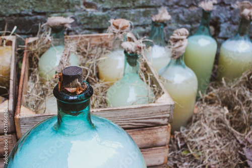 Vintage homemade moonshine bottles in wooden cases

 photo