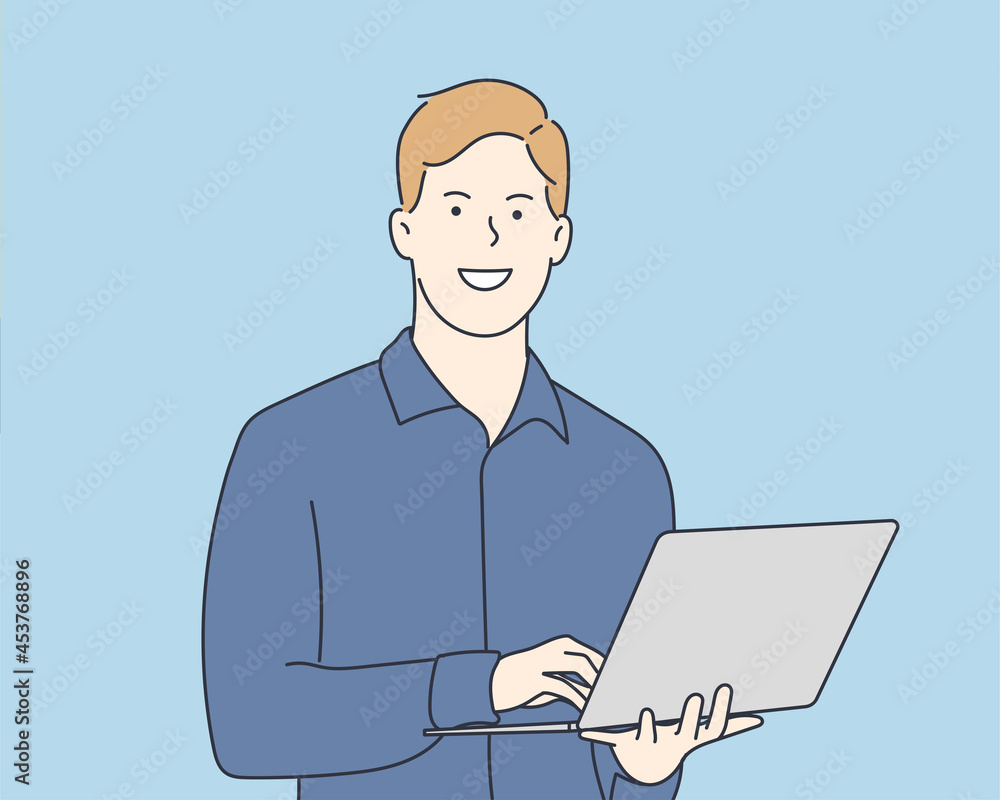 A young man standing holding a laptop with a happy expression. Hand drawn style vector design illustrations.