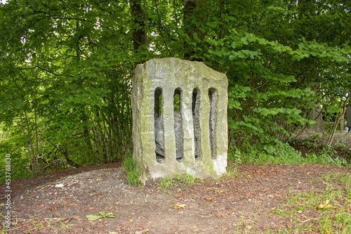 Single standing stone in a forest near the Maven lake in Mauensee, Switzerland photo