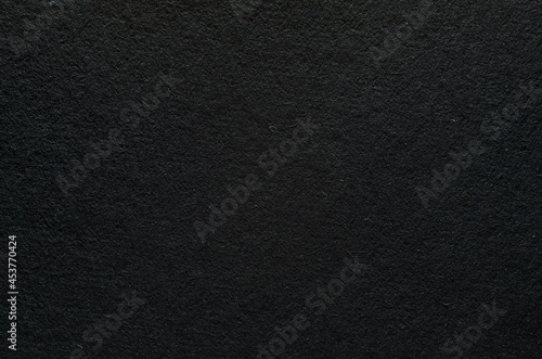 Rough texture of black paper with fibers, macro photography. Close-up paper background top view