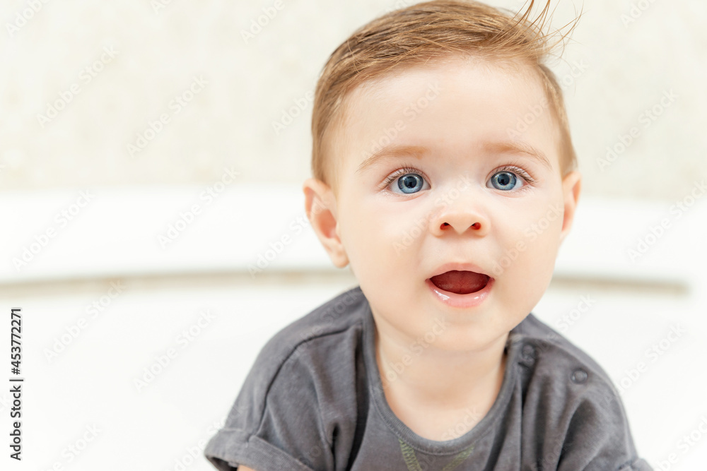 Close up portrait of cute smiling baby. Happy Caucasian child baby boy playing at home. Copy space for text