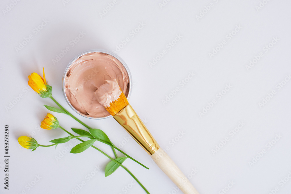 small beautiful flowers, makeup brush and cosmetic red clay in an aluminum jar, natural cosmetics small beautiful flowers, makeup brush and cosmetic red clay in an aluminum jar, natural cosmetics