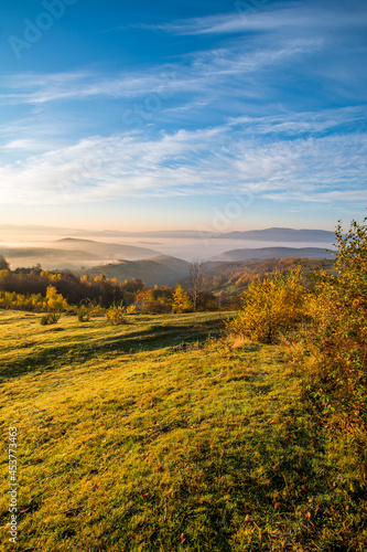 Autumn morning in the mountains in the fog with a beautiful field and sky. Nature's landscape.