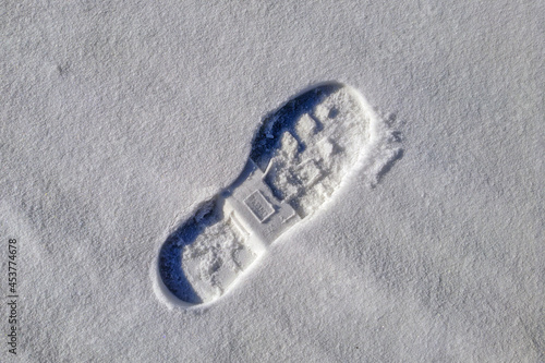 A human footprint on a snowy surface