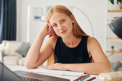 Positive woman. Female teenager with blonde hair is at home at daytime