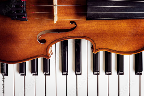 Violin on top of piano keys background