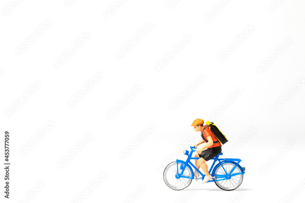Miniature people Bicycle courier with parcel box on the back isolated on white background ,Express delivery service concept Miniature people Bicycle courier with parcel box on the back isolated on white background ,Express delivery service concept
