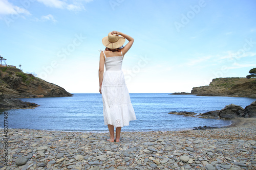 Back view of a woman standing on the beach