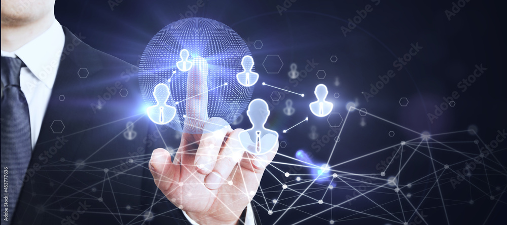 Businessman hand using glowing globe interface with people icons on dark background. Social networking and recruiting concept. Businessman hand using glowing globe interface with people icons on dark background. Social networking and recruiting concept.