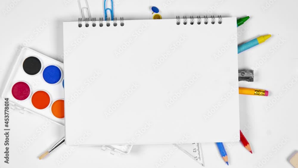 Colorful school supplies being moved underneath the notepad. School and Education concept. Blank white space for the text. Seamless loop. High quality 4k video. Colorful school supplies being moved underneath the notepad. School and Education concept. Blank white space for the text. Seamless loop. High quality 4k video.