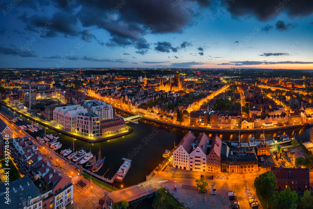 Amazing architecture of the main city in Gdansk at dusk, Poland. Aerial view of the historical Port Crane at the Motlawa river