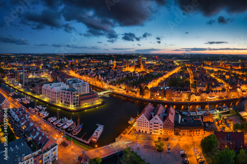 Amazing architecture of the main city in Gdansk at dusk, Poland. Aerial view of the historical Port Crane at the Motlawa river © Patryk Kosmider