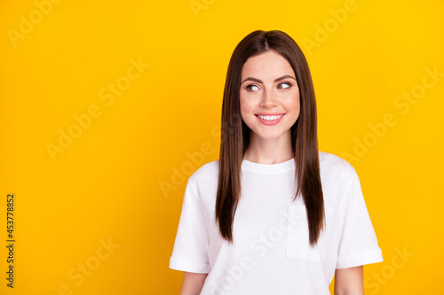 Photo of happy smiling positive good mood girl look copyspace dreaming thinking isolated on yellow color background