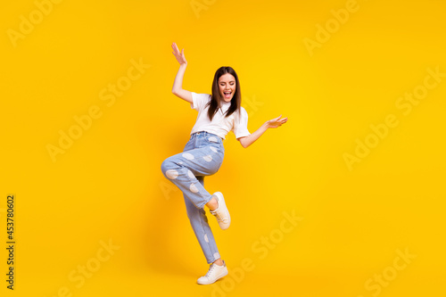 Full size photo of young excited girl happy positive smile have fun dance party isolated over yellow color background