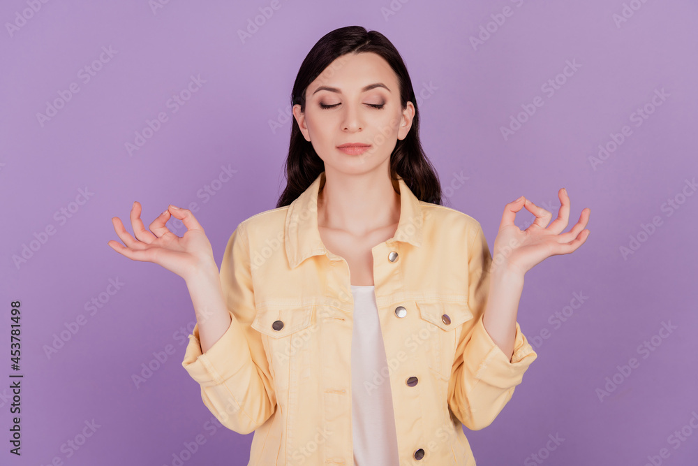 Portrait of calm lovely girl meditate yoga practice close eyes on violet background Portrait of calm lovely girl meditate yoga practice close eyes on violet background