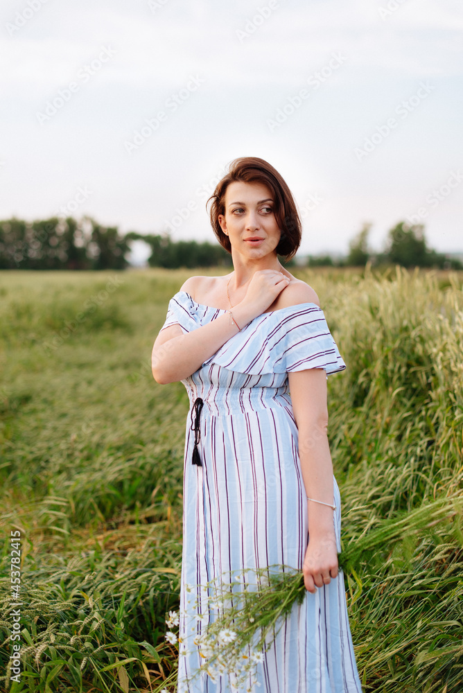 Beautiful young woman in summer in a wheat field Beautiful young woman in summer in a wheat field
