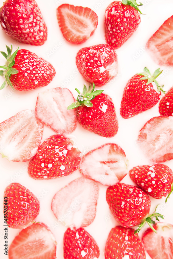 A lot of ripe juicy strawberries in milk, cream or yogurt. A lot of ripe juicy strawberries in milk, cream or yogurt.