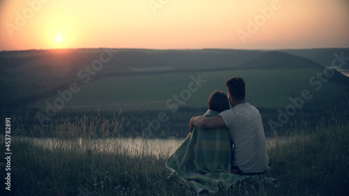 The man and woman admiring the beautiful sunset view