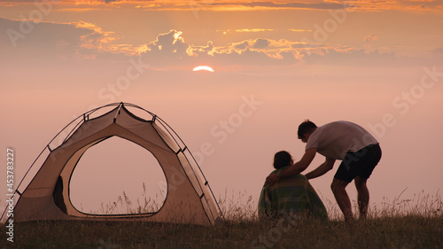 The man caring about his woman at the campsite