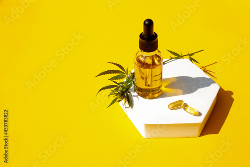 Medical marijuana cannabis oil on a yellow background. CBD oil hemp products