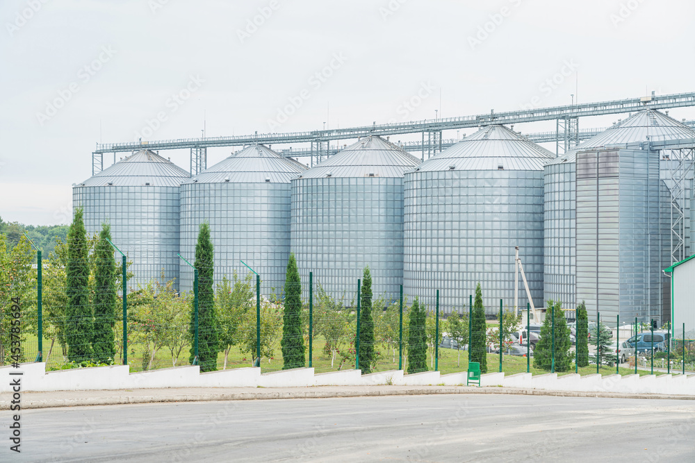 Granary. A large modern agro-processing plant for the storage and processing of grain crops. Large metal barrels of grain. Granary elevator. Granary. A large modern agro-processing plant for the storage and processing of grain crops. Large metal barrels of grain. Granary elevator.