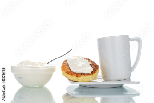 Several fragrant homemade cheesecakes with ceramic dishes, close-up, isolated on white.