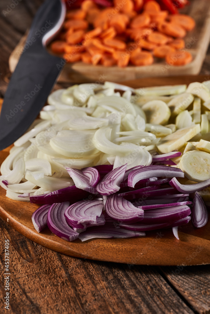 Onions and other vegetables on a chopping board